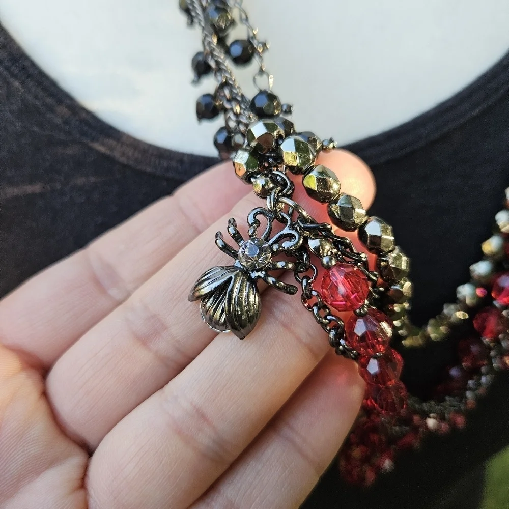 dark layered necklace with red beads flower spider fly charms